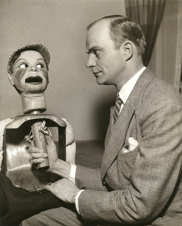 Edgar Bergen seated beside Charlie McCarthy with the figure's body opened, showing the head stick and the control levers inside